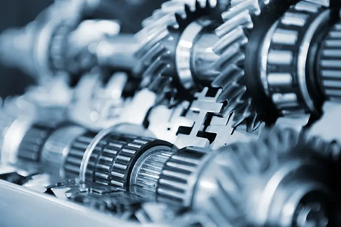 A close-up view of the gears of industrial manufacturing machinery
